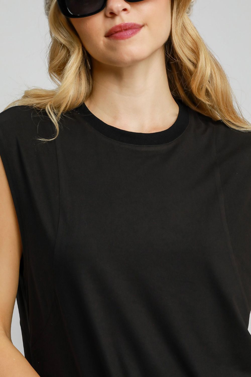 Aria® | Sleeveless mini dress with a round neckline and a high, low, curved hem