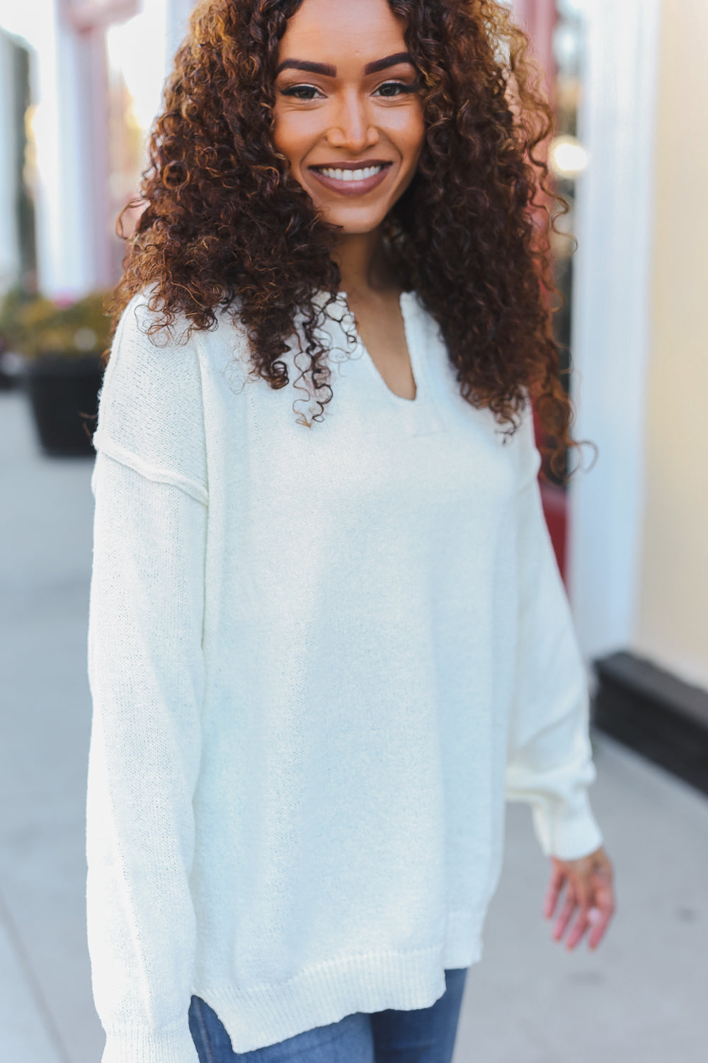 Avis® | Lock Eyes Ivory oversized sweater with notched neckline and patch