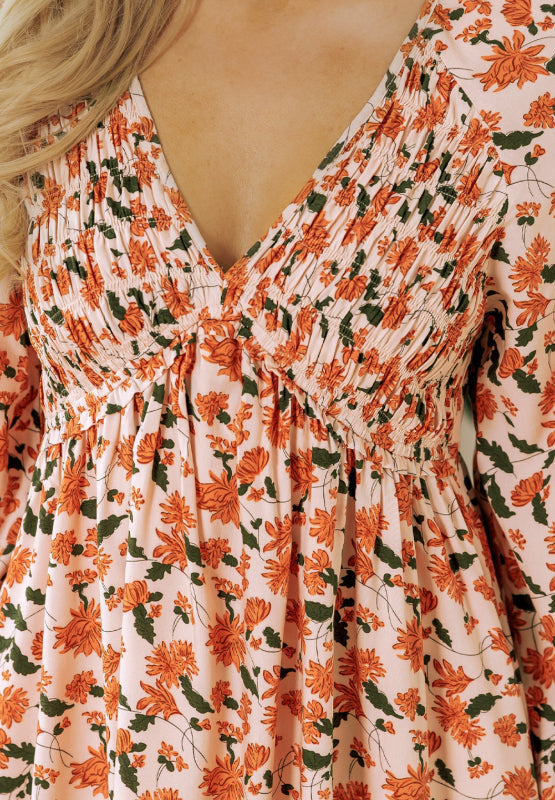 Amparo® | Smocked printed long sleeve dress with V-neck