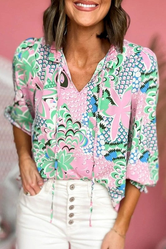 Clementine® | Green, loosely tied blouse with a floral pattern and a V-neck