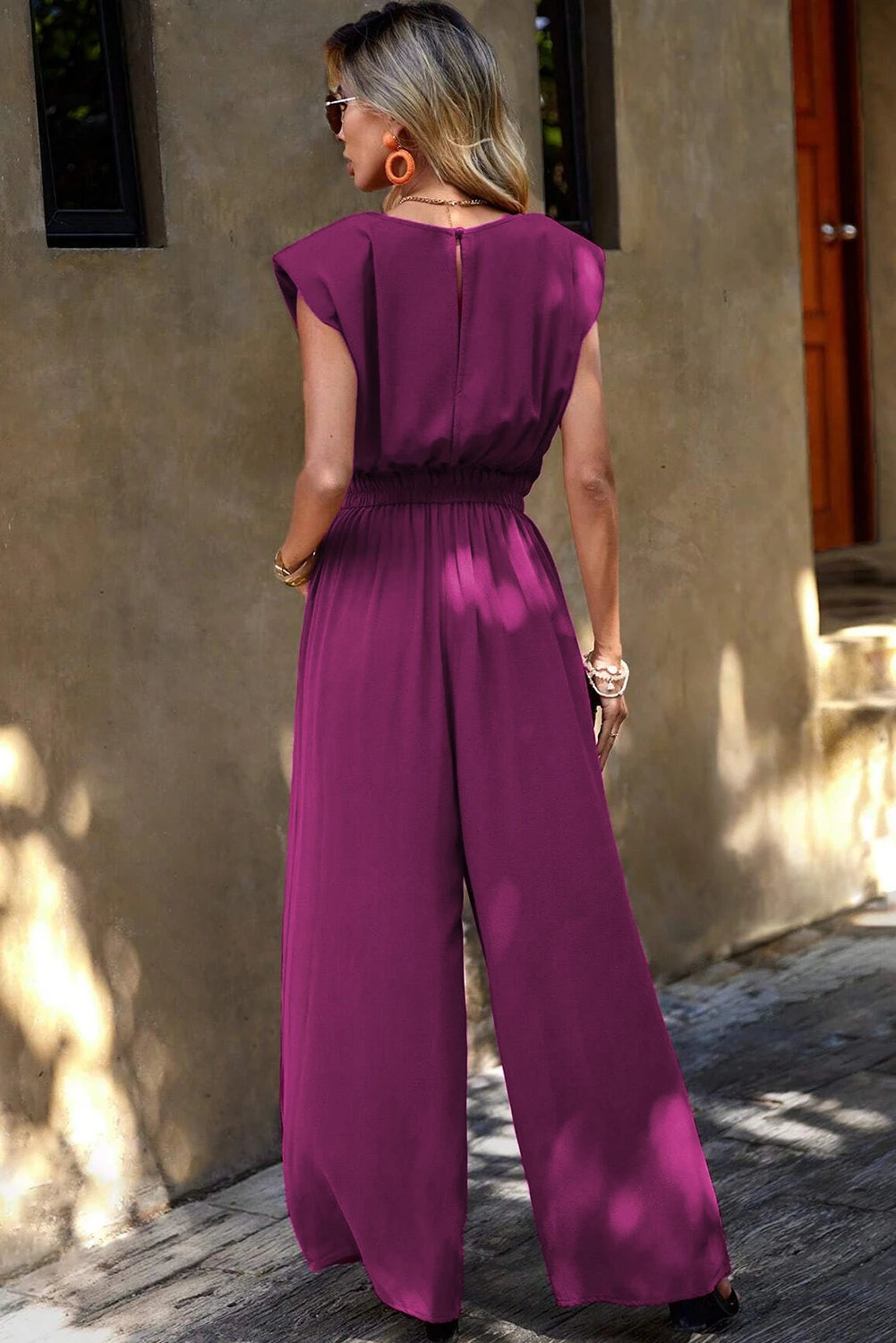 Elisa® | Pink jumpsuit with padded shoulders, slanted pockets and wide legs