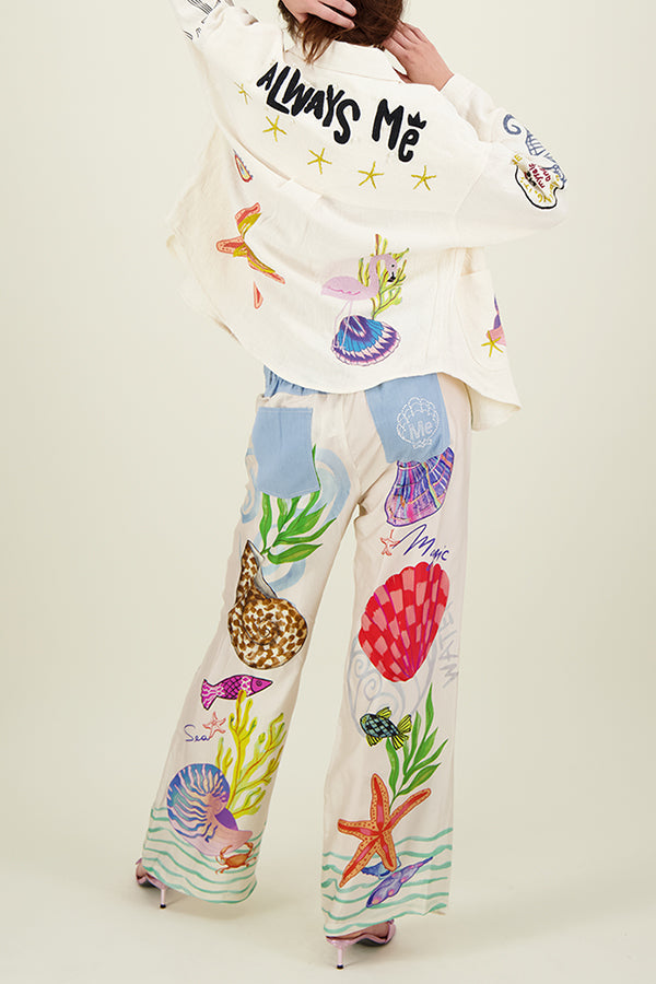 Ana® | Satin pants with a unique print on the back, elastic waist, pockets and wide leg
