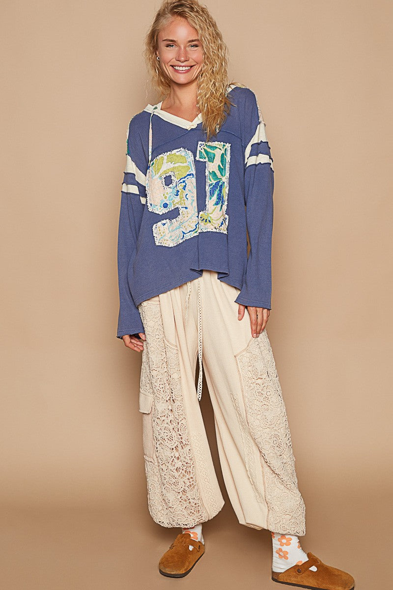 Benita | POL hooded top with exposed seam and number patch and V-neck