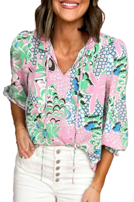 Clementine® | Green, loosely tied blouse with a floral pattern and a V-neck